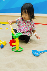 Image showing Chinese children playing at indoor sandbox.