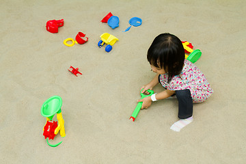 Image showing Chinese children playing at indoor sandbox.