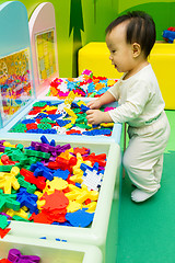 Image showing Chinese baby playing puzzle