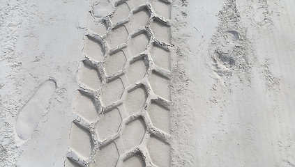 Image showing Wheel track and footprints on the sand