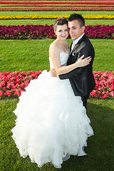 Image showing Bride and groom posing on lawn