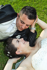 Image showing Newlyweds on grass looking at each other