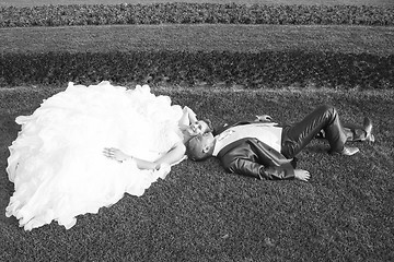 Image showing Newlyweds posing on lawn black and white