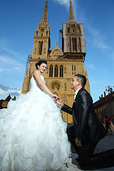 Image showing Bride and groom in front of cathedral