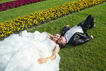 Image showing Married couple lying on lawn