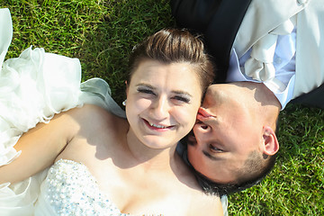 Image showing Newlyweds kissing on grass