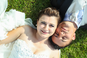 Image showing Newlyweds posing on grass