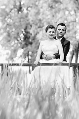 Image showing Married couple on wooden bridge bw