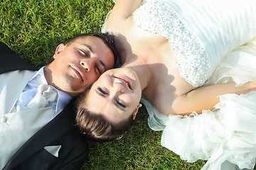 Image showing Newlyweds lying on grass