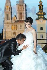 Image showing Groom kissing bride on stomach