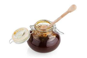 Image showing Jar of honey with wooden drizzler