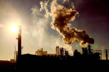 Image showing Smoking chimney  at sunset 