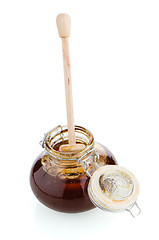 Image showing Jar of honey with wooden drizzler