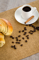 Image showing Cup of black coffee and croissant 