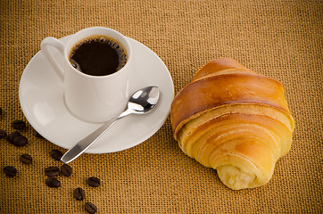 Image showing Cup of black coffee and croissant 