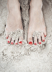 Image showing woman feet on the sand
