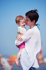 Image showing mom and baby on beach  have fun