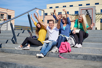 Image showing students outside sitting on steps