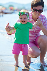 Image showing mom and baby on beach  have fun