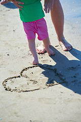 Image showing mom and baby on beach  have fun