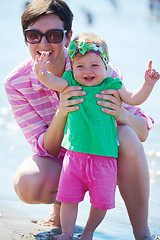 Image showing mom and baby on beach  have fun