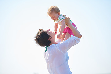 Image showing mom and baby on beach  have fun