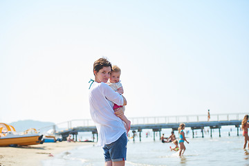 Image showing mom and baby on beach  have fun