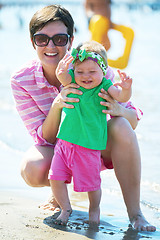 Image showing mom and baby on beach  have fun