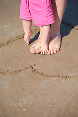 Image showing mom and baby on beach  have fun