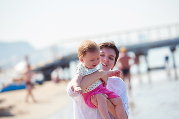 Image showing mom and baby on beach  have fun