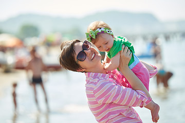 Image showing mom and baby on beach  have fun