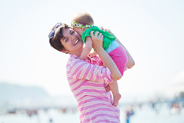 Image showing mom and baby on beach  have fun