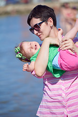 Image showing mom and baby on beach  have fun