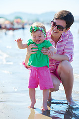 Image showing mom and baby on beach  have fun