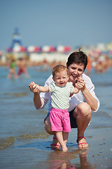 Image showing mom and baby on beach  have fun