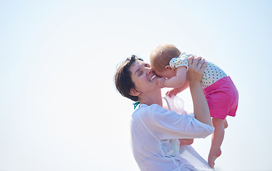 Image showing mom and baby on beach  have fun