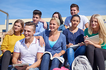 Image showing students outside sitting on steps