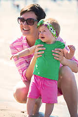 Image showing mom and baby on beach  have fun