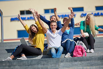 Image showing students outside sitting on steps