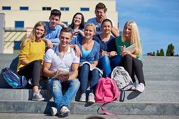 Image showing students outside sitting on steps