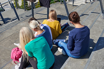 Image showing students outside sitting on steps