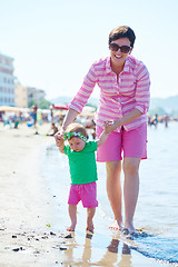 Image showing mom and baby on beach  have fun