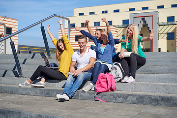 Image showing students outside sitting on steps