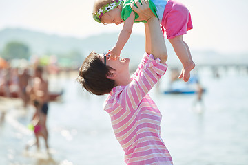 Image showing mom and baby on beach  have fun