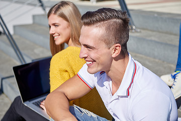 Image showing students outside sitting on steps