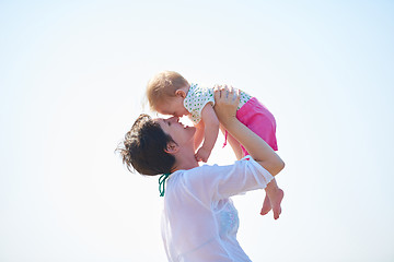 Image showing mom and baby on beach  have fun