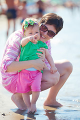 Image showing mom and baby on beach  have fun