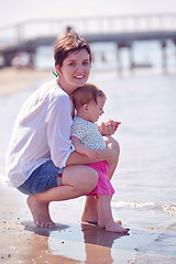 Image showing mom and baby on beach  have fun