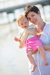 Image showing mom and baby on beach  have fun