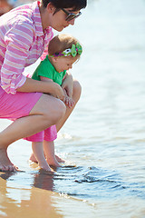 Image showing mom and baby on beach  have fun